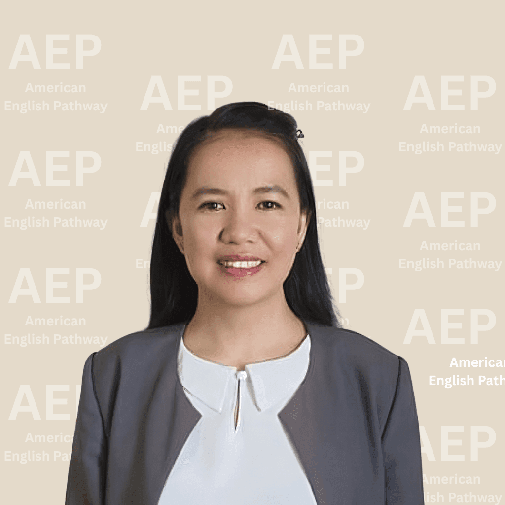 Person in a suit smiling in front of an American English Pathway background.