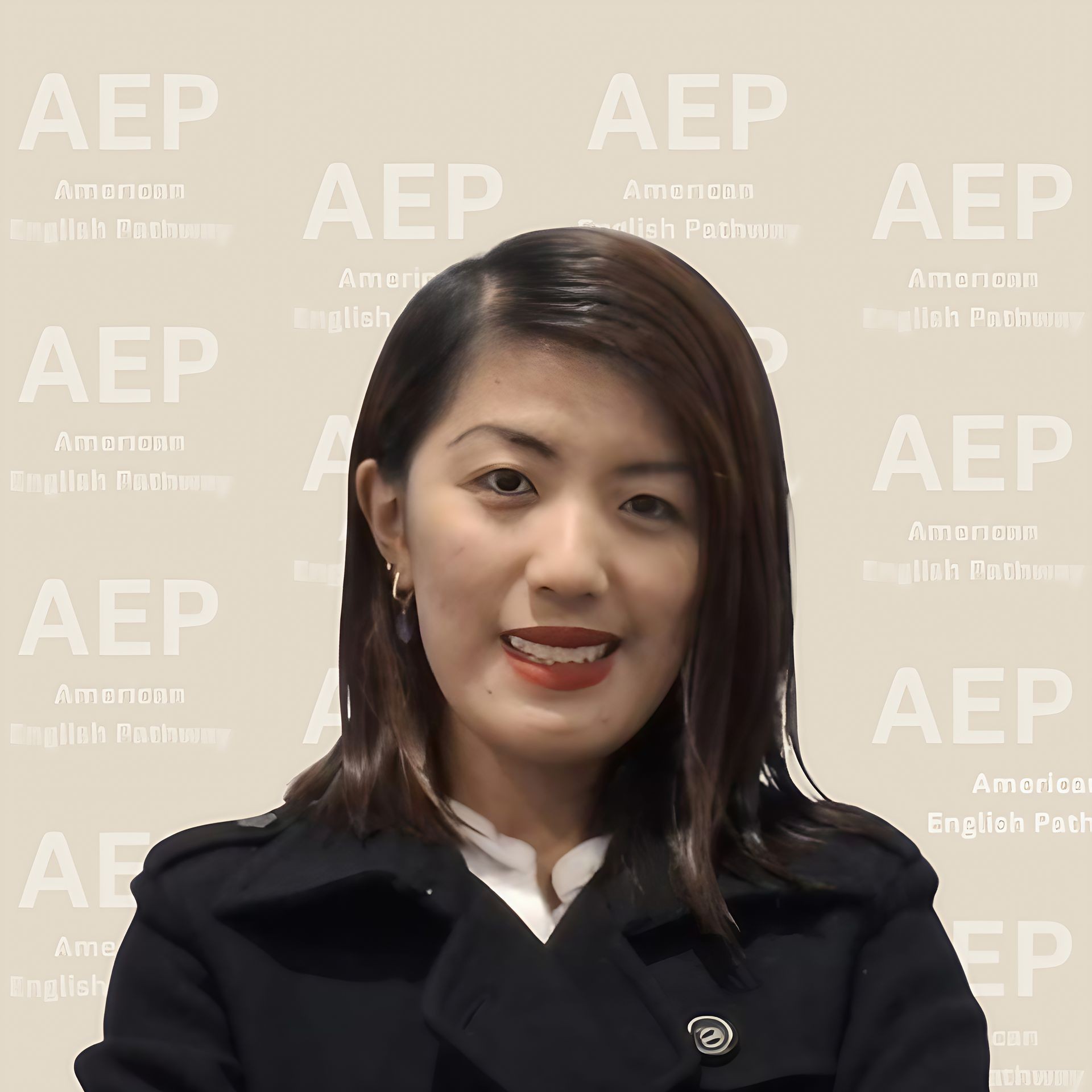 Person smiling in front of a backdrop with 'AEP American English Pathway' repeated.